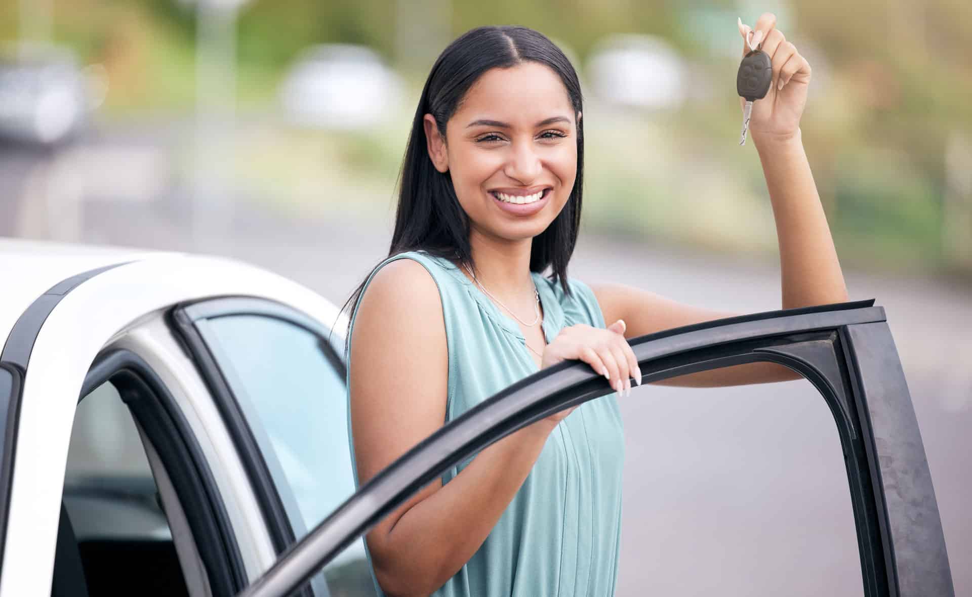 Woman with a key to her new EV